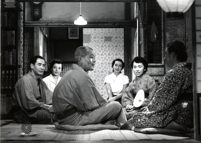 Six family members seated on the floor.