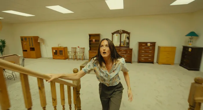 Woman climbing stairs in furniture store.