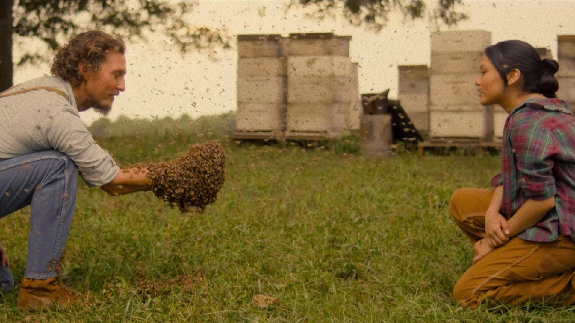 McConaughey surrounded by bees, with a big swarm of them on his hand.