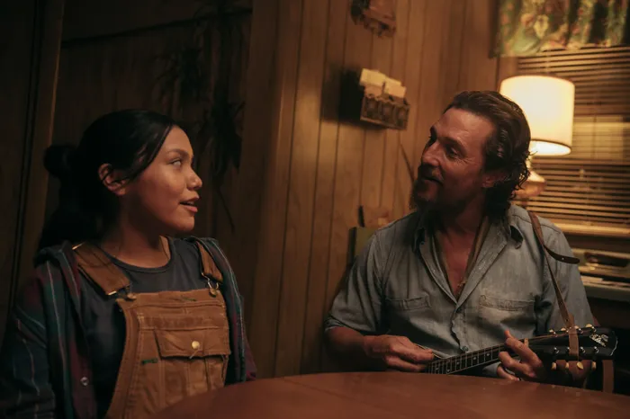 LookingGlass and McConaughey at a table. McConaughey plays a six-string mandolin.
