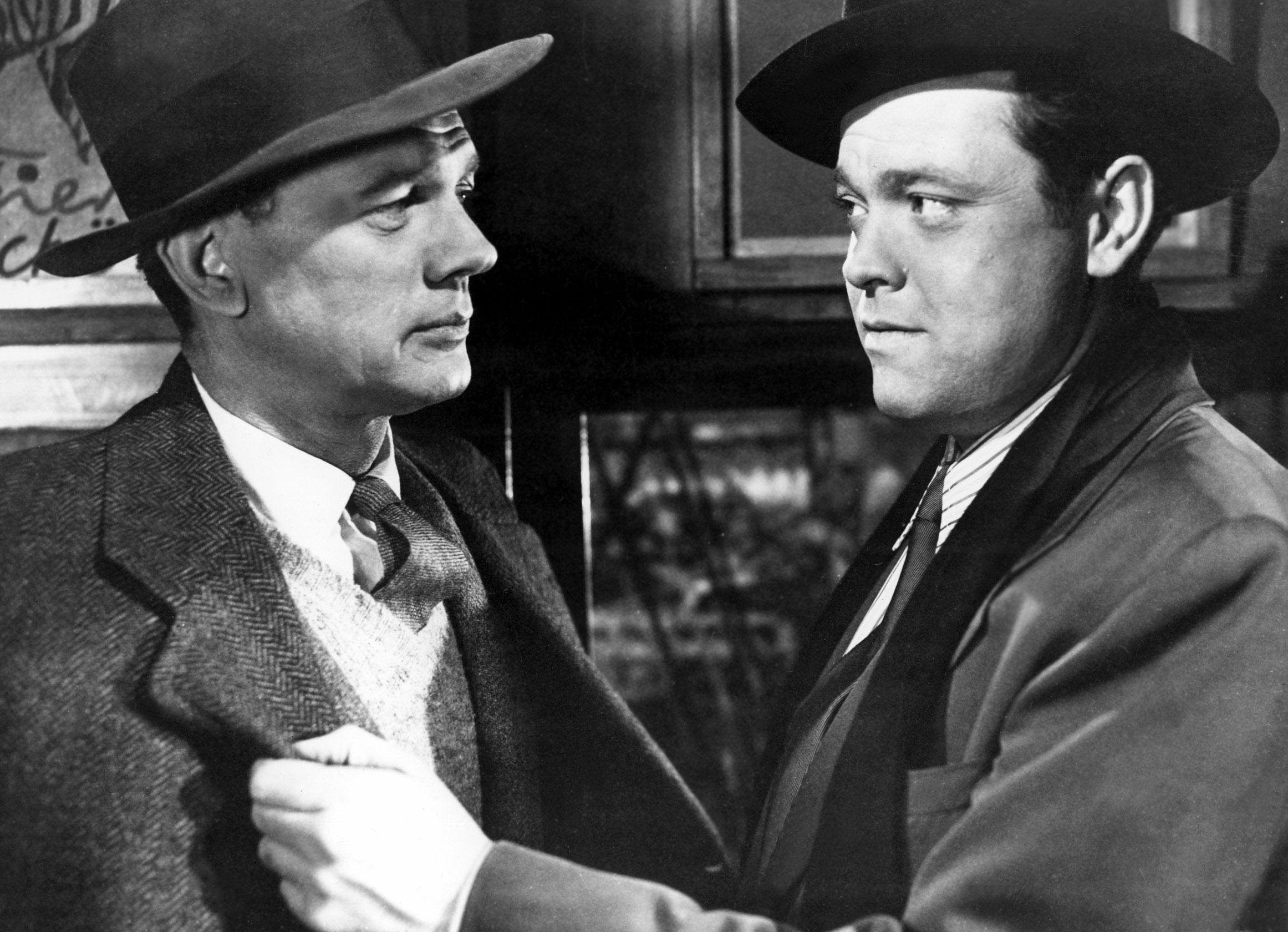 Welles grabs Cotton by the lapels.